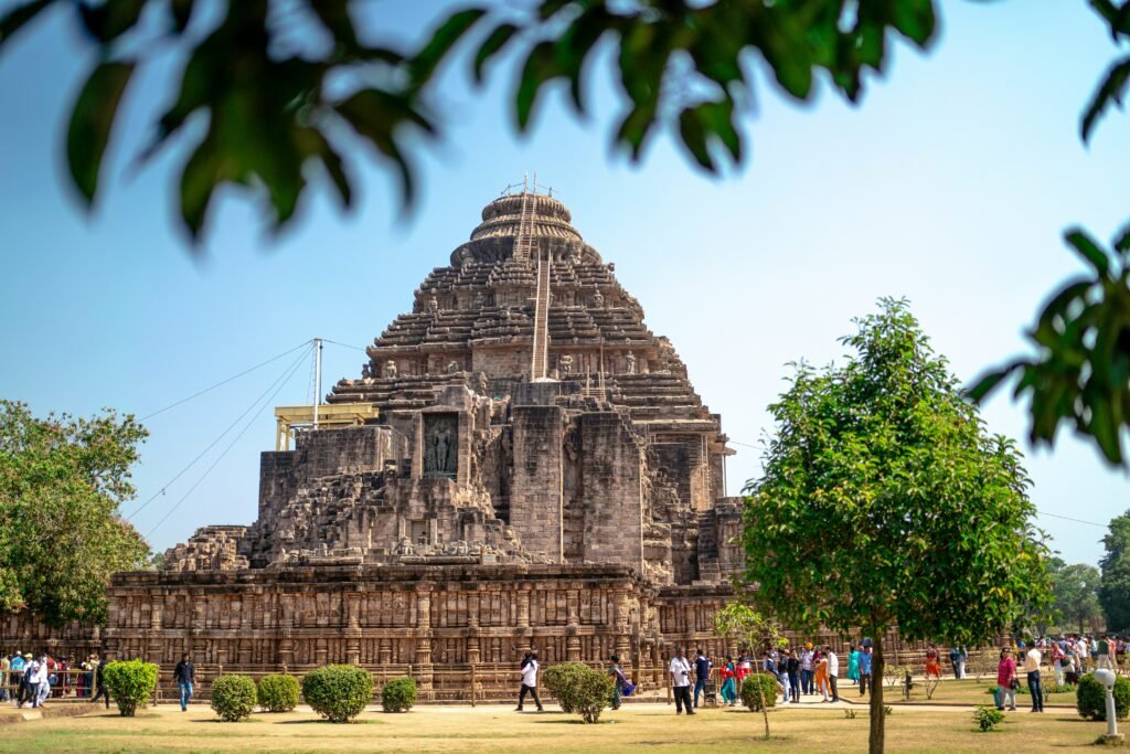 Where to Stay in Odisha, Best Areas and Stays 2 Konark Sun Temple's carved stone facade with visitors on the surrounding lawn