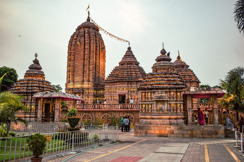 Carved sandstone temple spires in Bhubaneswar with a stone chariot-wheel base