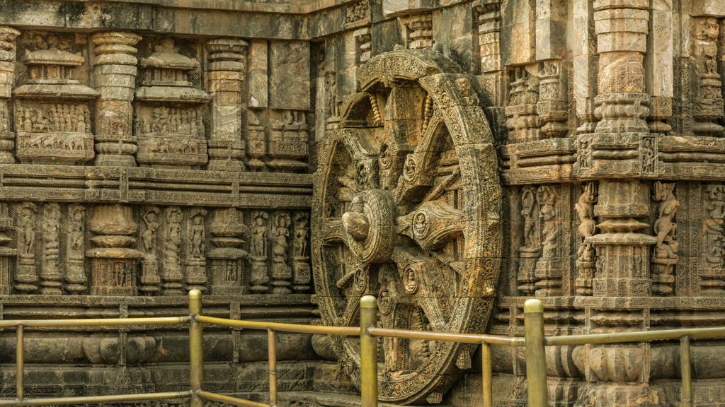 Carved stone chariot wheel at Konark Sun Temple with sundial detail
