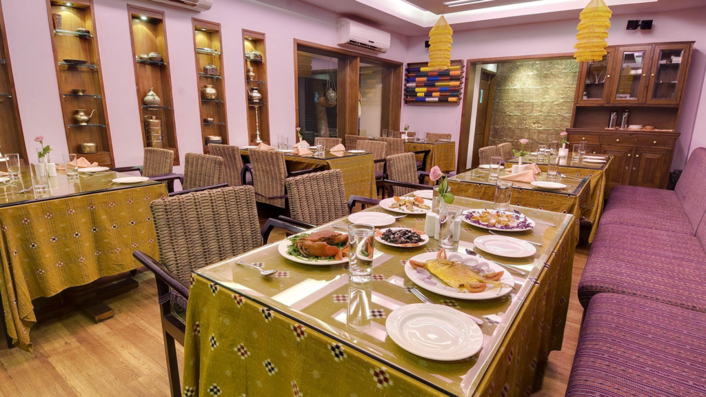 Elegant dining room with crab and fish dishes served, a more polished setting for Odia cuisine in Bhubaneswar