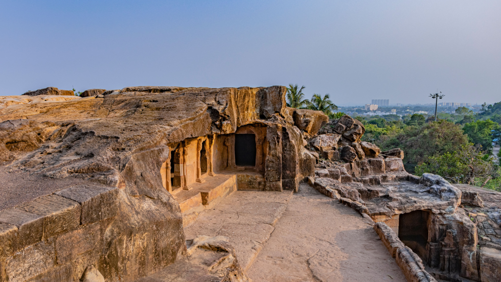 Rock-cut Jain cells at Udayagiri Caves on a hilltop overlooking Bhubaneswar, a stop often skipped on a Puri to Bhubaneswar one day tour