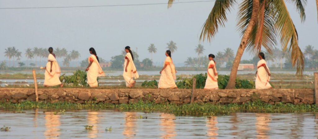 Women walking along the Kerala backwaters near Alleppey, an optional add-on to this customized tour package in India
