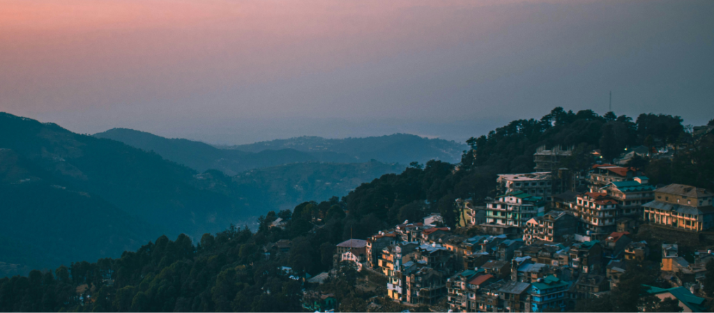 Best Places to Visit in Dalhousie, Himachal 5 Best Places to Visit in Dalhousie - A scenic twilight or sunset view over the rolling hills and clustered rooftops of Dalhousie, a popular colonial-era hill station in Himachal Pradesh, India.