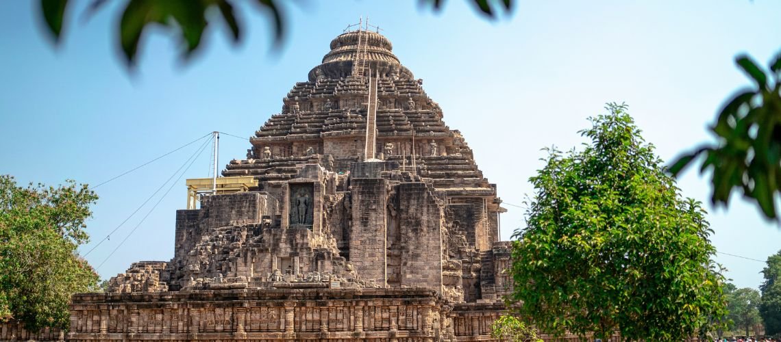 Konark Sun Temple in Odisha, India, is a 13th-century architectural wonder shaped like a giant sun chariot with carved stone wheels and horses | Best Things to Do in Odisha