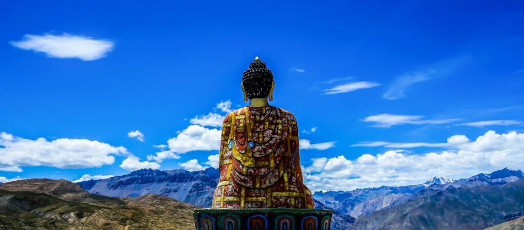 Lord Buddha statue sitting atop a hill in Langza village, located in the high-altitude Spiti Valley of Himachal Pradesh, India. 