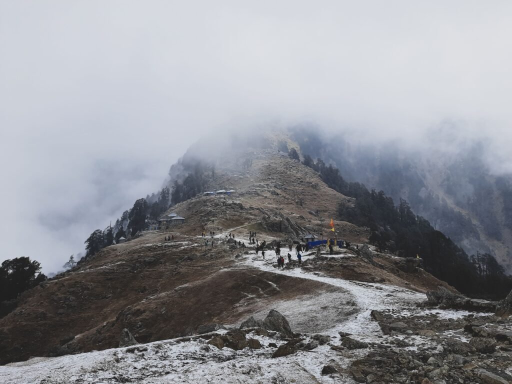 Best Things to Do in Dharamshala: A Complete Guide 1 Snow-covered Triund trek with hikers and misty Dhauladhar mountains, Dharamshala