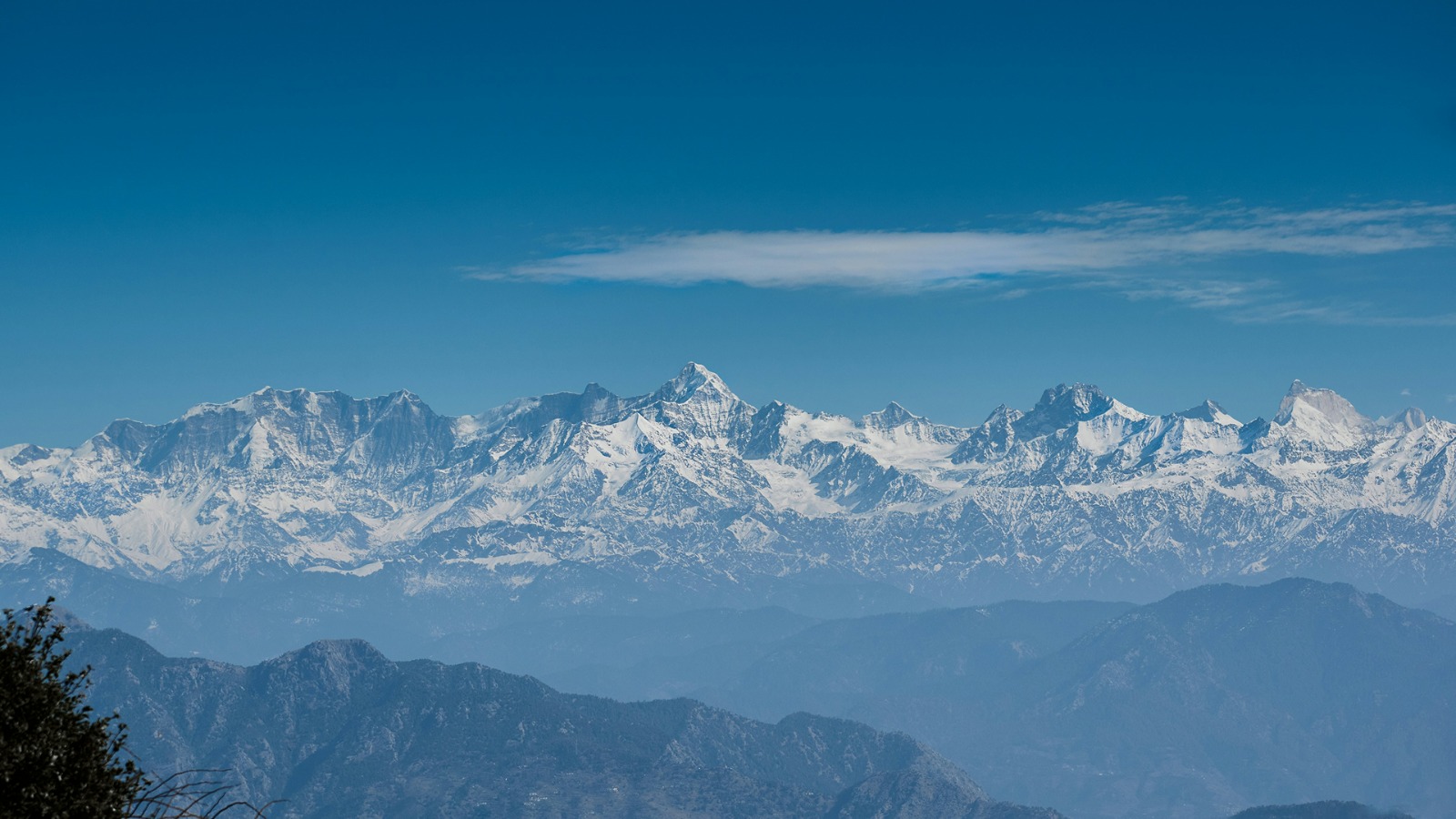 Snow-capped Himalayan range under a clear blue sky, the backdrop to a Shimla Manali family tour package